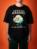 A person wearing an oversized black graphic T-shirt with a cartoon cloud and the text 'LET'S DO CARDIO! JUST KIDDING' against a solid orange background.