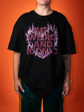 a female wearing a hot, weird and iconic print on a black t-shirt on an orange background 