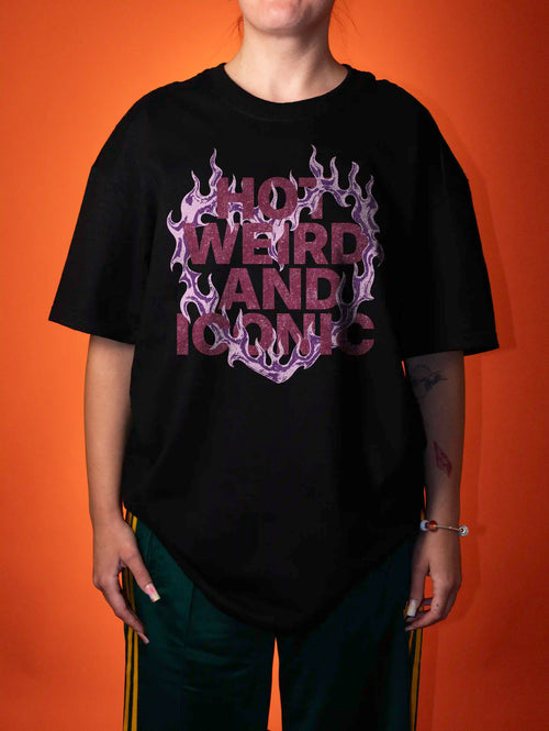 a female wearing a hot, weird and iconic print on a black t-shirt on an orange background 