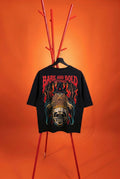 Black t-shirt with graphic design and 'Bare and Bold' text on a red stand against an orange background