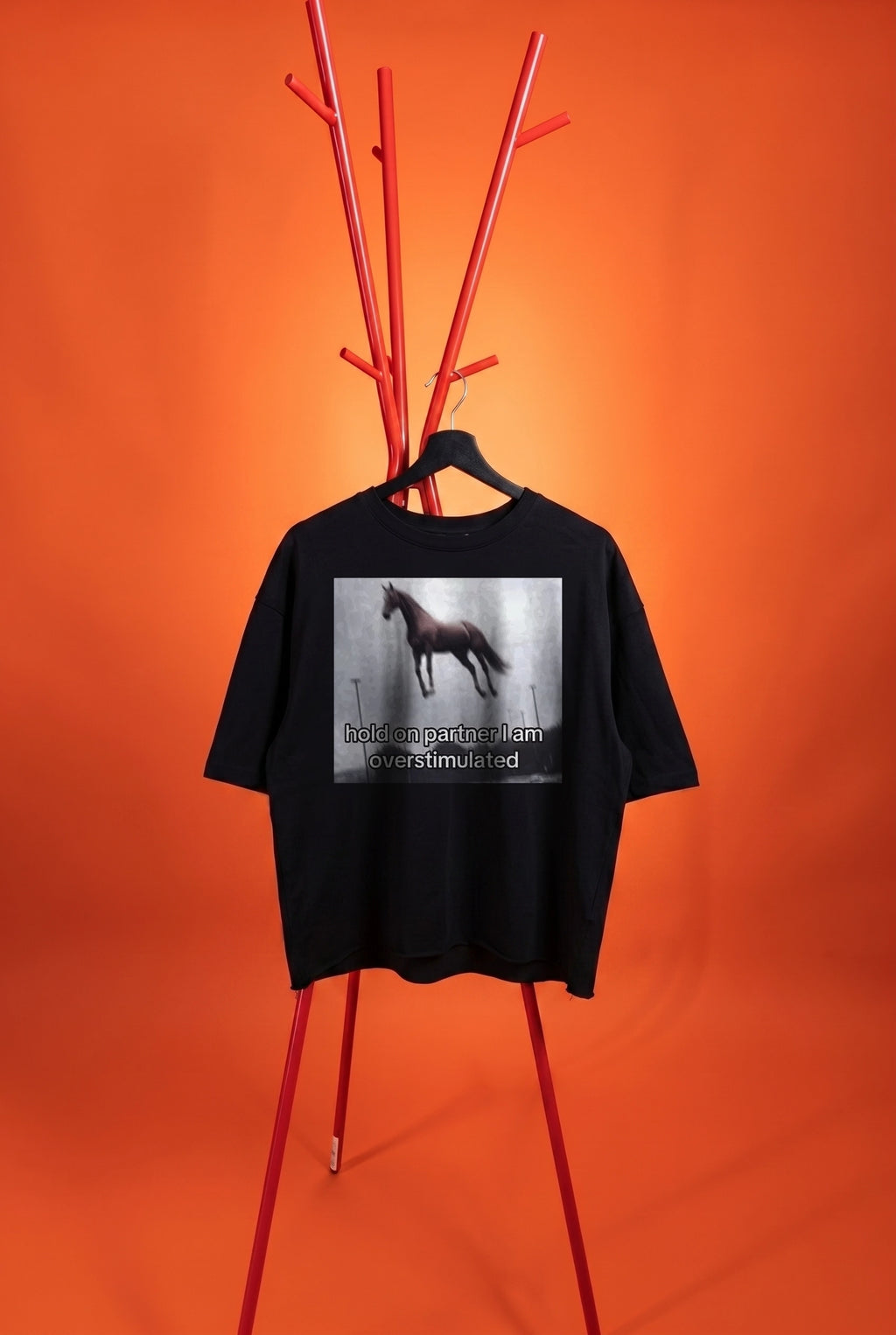 black t-shirt with an image with a horse on an orange background