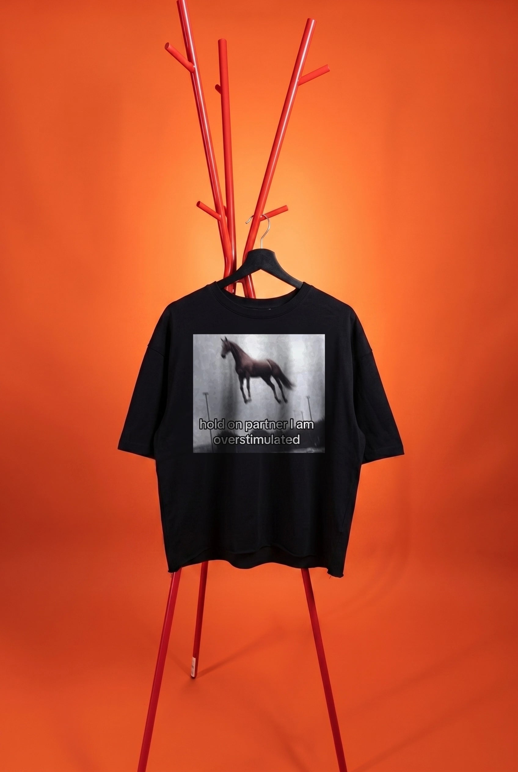black t-shirt with an image with a horse on an orange background