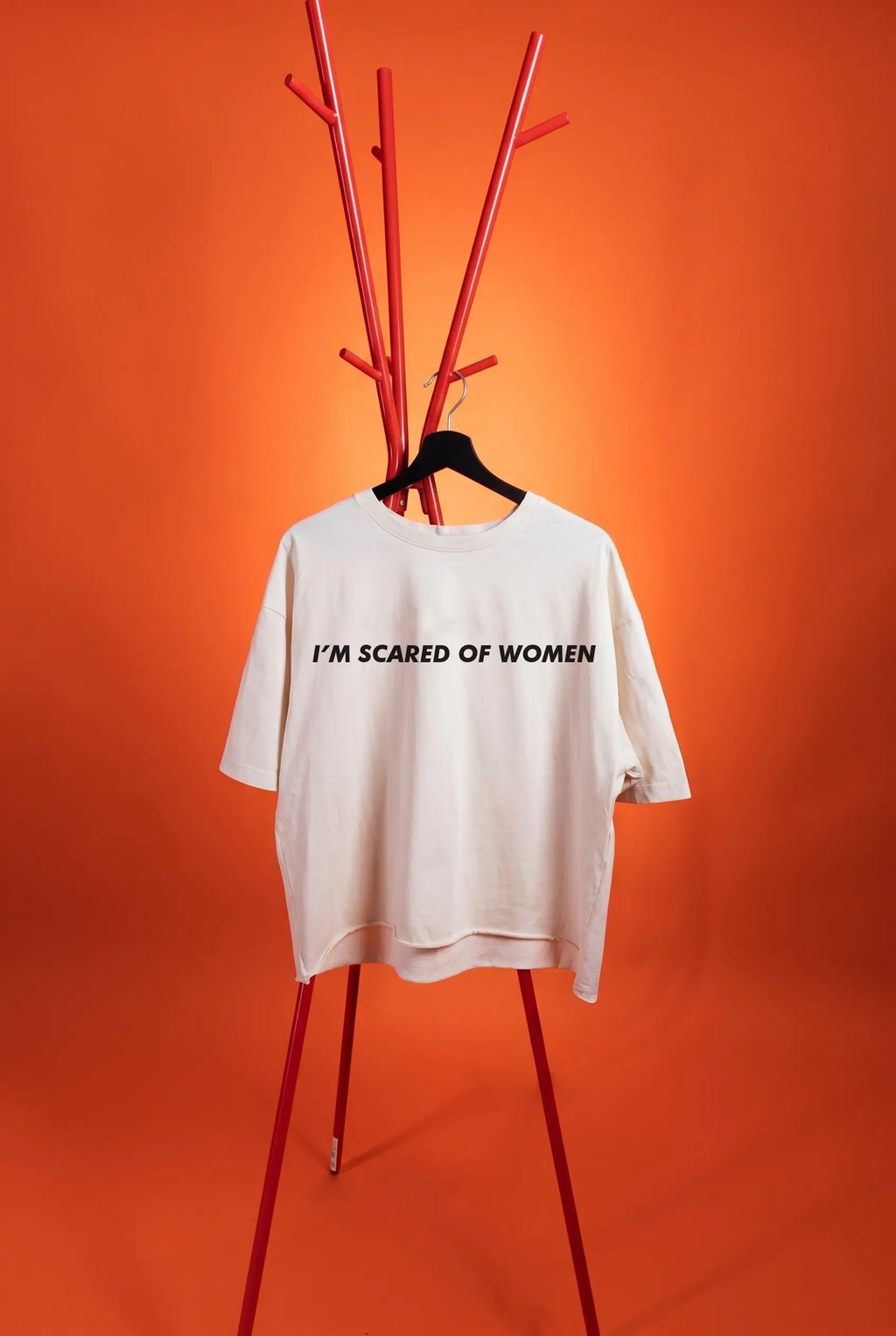 white t-shirt with text "i'm scared of Women" on an orange background