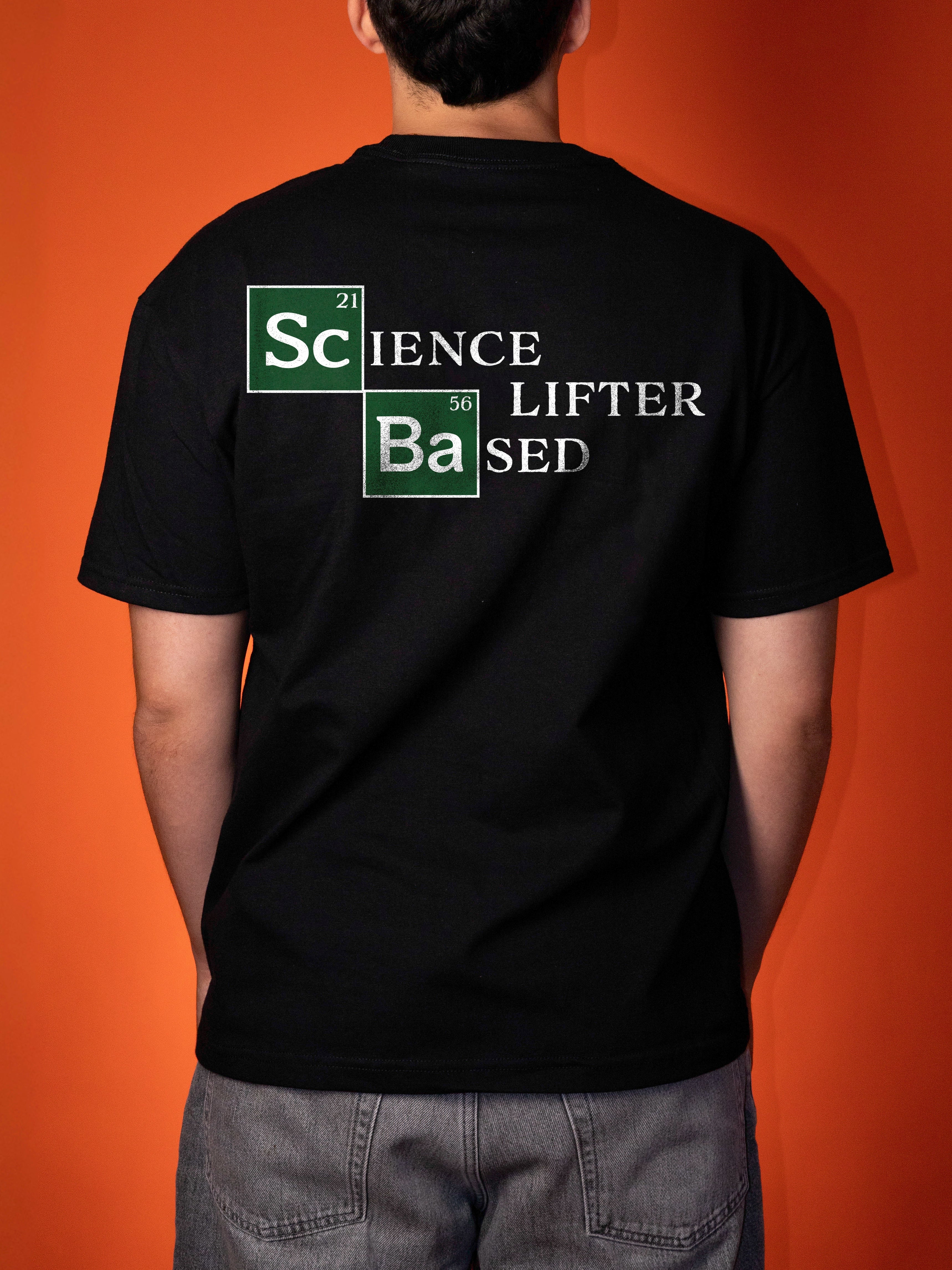 A person viewed from the back wearing a black t-shirt with a 'Science Lifter sed' graphic printed on the back, set against a solid orange background.